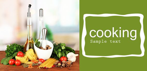 Composition of mortar, pasta and green herbals, on bright background - Foto, imagen
