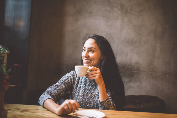 beautiful woman drinking coffee in a cafe - Photo, Image