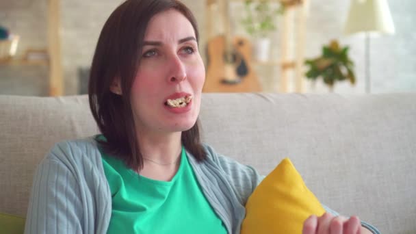 Portrait of a young woman with toothache while eating - Video