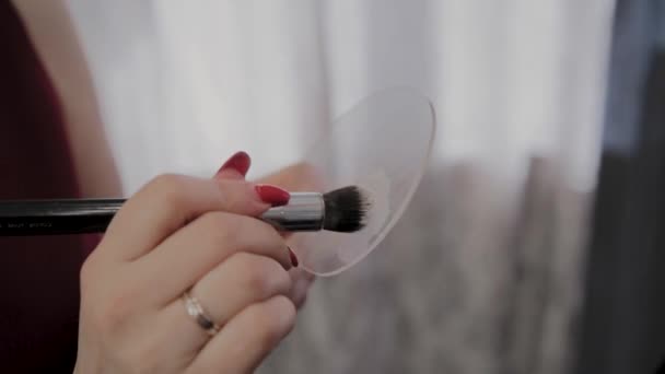 Professional makeup artist holds tool for visage in hands - Footage, Video