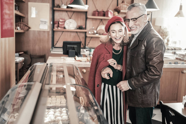 Positive delighted mature people choosing sweets for coffee - Photo, image