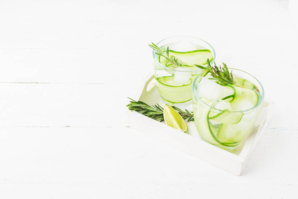 Fresh cucumber drink sprig of rosemary on a white background. Summer refreshing detox. Selective focus. - Photo, Image