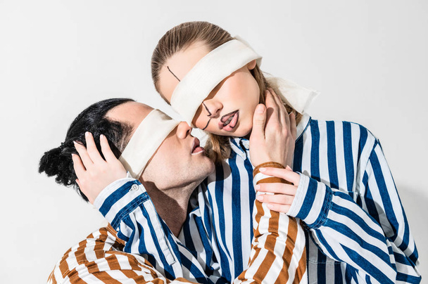 Couple of models having blindfolds and lines on faces - Фото, зображення