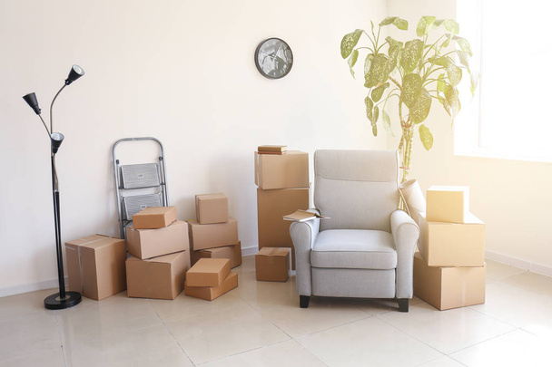 Furniture with moving boxes in room - Photo, Image