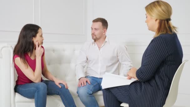 Unhappy couple sharing emotions with psychologist - Footage, Video