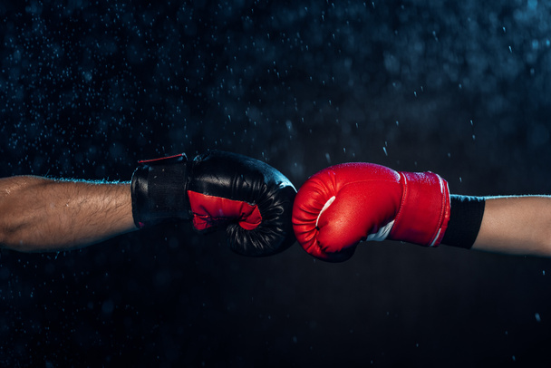 Osittainen näkymä kaksi nyrkkeilijää nyrkkeilyhanskat koskettaa käsiä musta
 - Valokuva, kuva