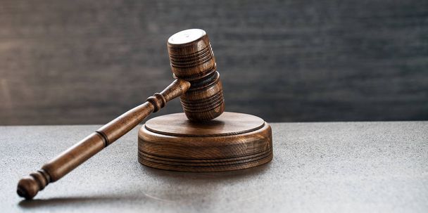 Huge judge's wooden gavel on blurred background - Foto, afbeelding