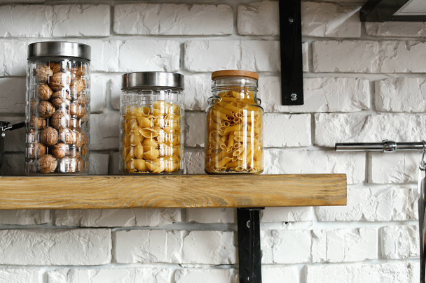 Jars with products on kitchen shelf - Foto, Imagen