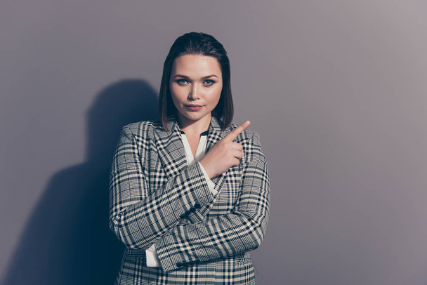 Closeup photo portrait of confident serious charming thoughtful office lady making choice pointing with forefinger looking at camera isolated grey background - Photo, Image