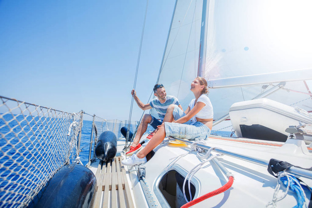 Father with adorable daughter resting on yacht - 写真・画像