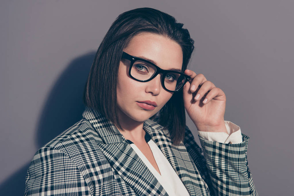 Closeup photo of beautiful serious attractive pretty with ideal perfect makeup bob dark brown haircut touching adjusting black specs wearing white collar suit isolated grey background - Foto, afbeelding