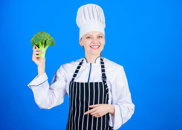 Including healthy organic foods in your life. Happy woman chef holding natural cabbage for healthy diet. Lady cook smiling with healthy green broccoli in hand. For a truly healthy and enjoyable dish - Photo, Image