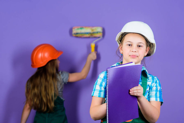 Kids happy renovating home. Repaint walls. Home improvement activity. Kids girls planning renovation. Violet is my favorite color. Children sisters renovation their room. Control renovation process - Фото, изображение