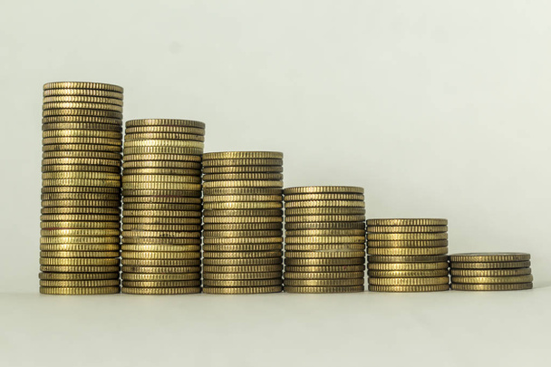 Stacks of copper coins on a white background. Ascending movement. A good image for a site about finance, money, collection, relationships. - Photo, Image