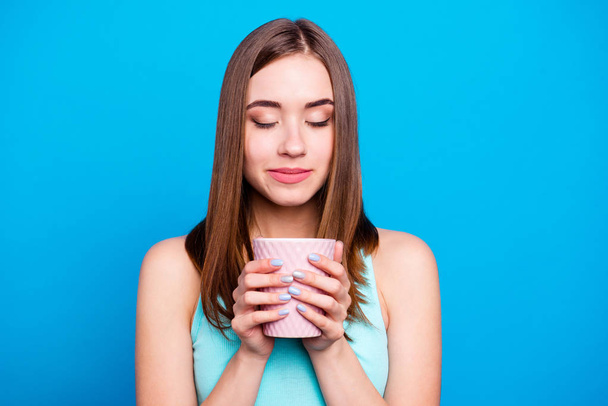 Portrait of pretty attractive lady holding hot drink cup shop feeling nice smell enjoying isolated having weekends holidays dressed in blue clothing on azure background  - Fotoğraf, Görsel