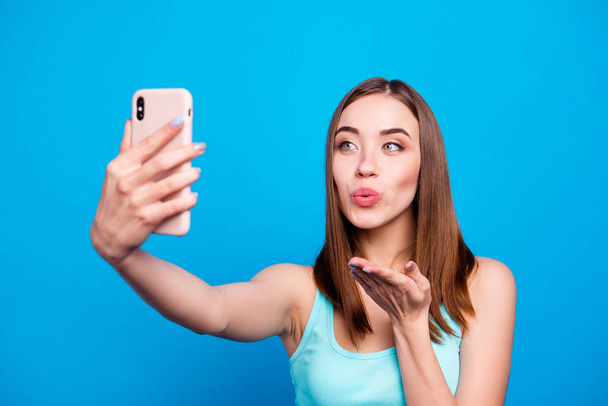 Close up photo beautiful amazing she her lady hold hands arms telephone make take selfies send air kisses instagram followers wishing best day wear casual tank top clothes isolated blue background - Foto, Imagem