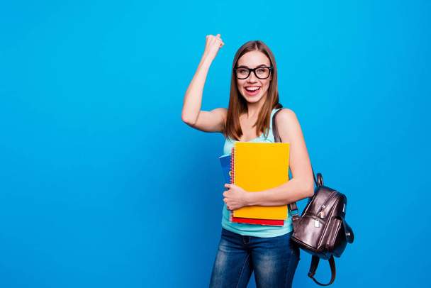 Close up photo funky beautiful amazing she her lady celebrate end exams raised fist yeah hold schoolgirl study applies back bag wear specs casual jeans denim tank top clothes isolated blue background - Фото, зображення