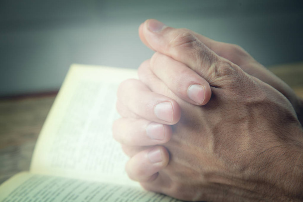praying hands over a holy bible - Фото, зображення