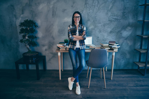 Full length body size view of nice attractive lovely slim thin fit cheerful brunette lady in checked shirt jeans denim trend at industrial loft style interior work place station indoors - Foto, Imagem