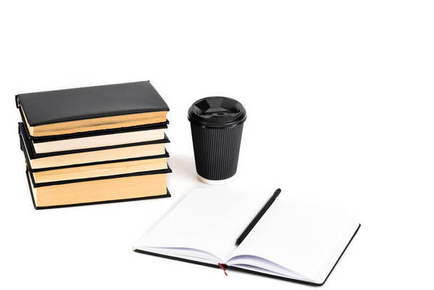 Stack of books, paper cup, notebook and pencil on white - Фото, изображение