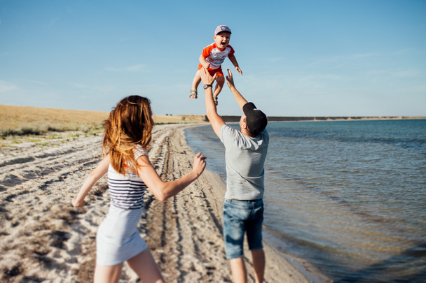 Funny portrait of a happy family on the beach. - Photo, Image