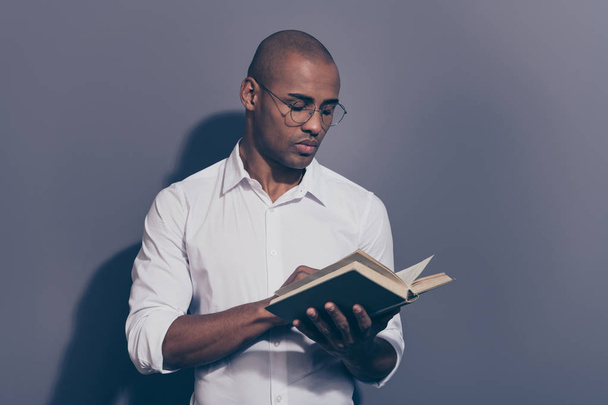 Close up photo amazing stunning dark skin he him his macho arms hands hold paper diary planner change sheets reader not smiling wondered shaved face wear specs white shirt isolated grey background - Foto, imagen
