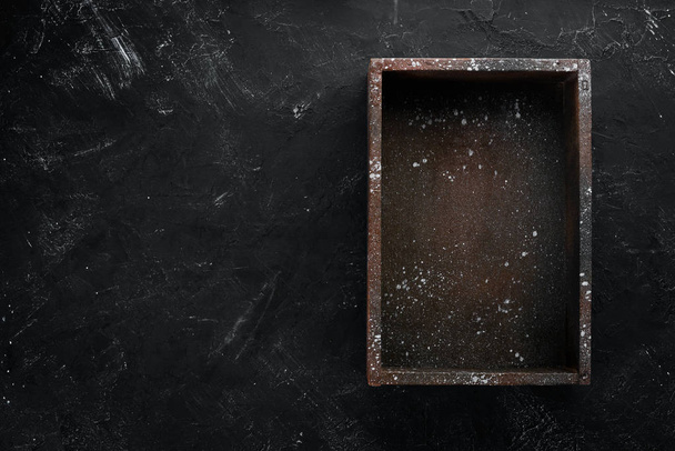 Old wooden black box. On a black stone background. Top view. Free copy space. - Valokuva, kuva