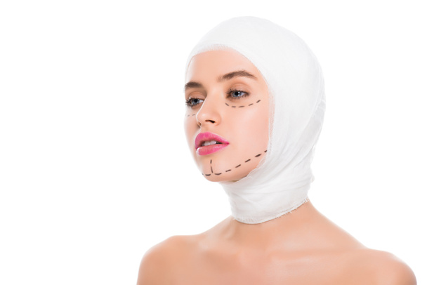 pretty woman with bandaged head and marks on face isolated on white  - Фото, изображение