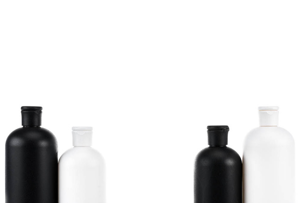Black and white cosmetic bottles isolated on white - Fotoğraf, Görsel