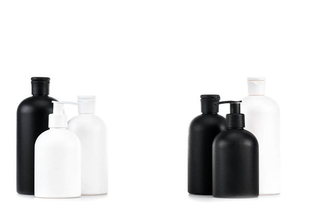 Black and white cosmetic bottles isolated on white - Фото, изображение