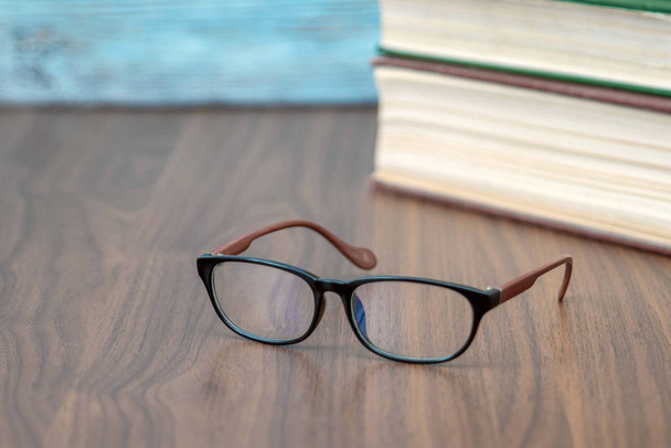 Glasses and book on blue background - Zdjęcie, obraz