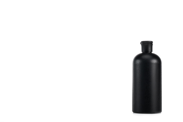 Black cosmetic bottle with cap isolated on white - Photo, Image