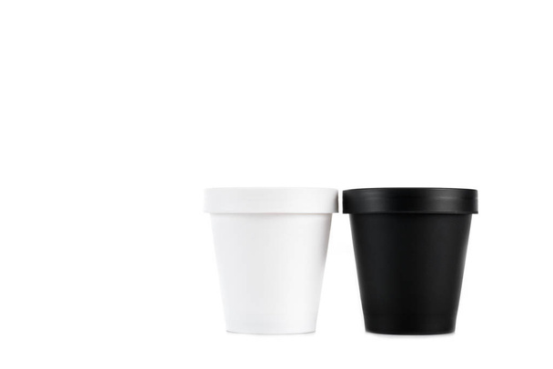White and black plastic cups isolated on white - Fotoğraf, Görsel