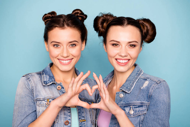 Close up photo of funny funky satisfied ladies teenagers showing their fellowship love dressed in childish denim shirts isolated on blue background  - Foto, afbeelding