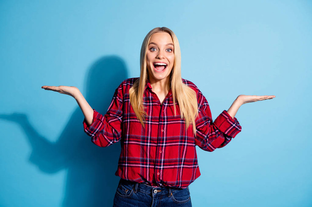 Portrait of nice pretty millennial astonished impressed by news recommendation choice decision advertising isolated wear checkered clothing on bright background - Fotografie, Obrázek