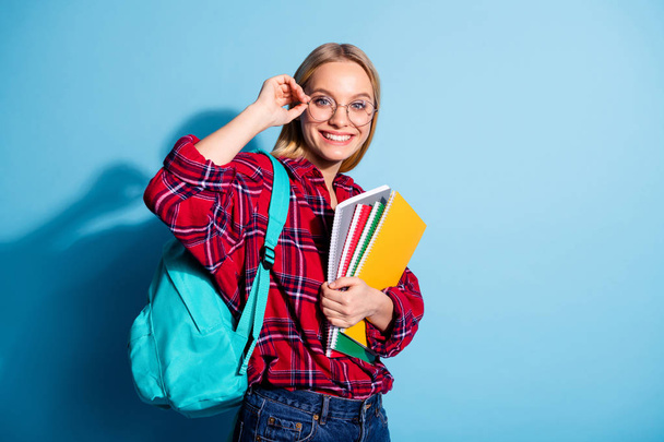Portrait of her she nice charming cute attractive winsome cheerful teen girl wearing checked shirt holding in hands copy-book note-book isolated on teal turquoise bright vivid shine background - Фото, зображення