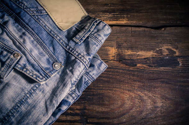 Denim jeans on the wooden table - Foto, Imagem