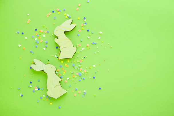 colorful background for easter, wooden bunnies and sweets - 写真・画像