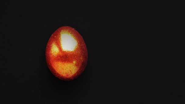 one golden easter eggs on black background. banner for text - Foto, Imagem