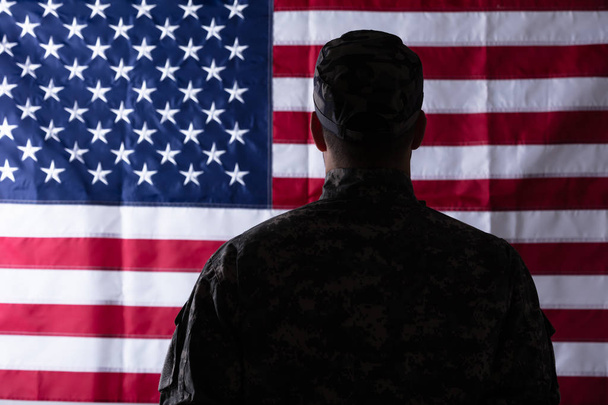 Rear View Of Soldier In Front Of Us Flag - 写真・画像