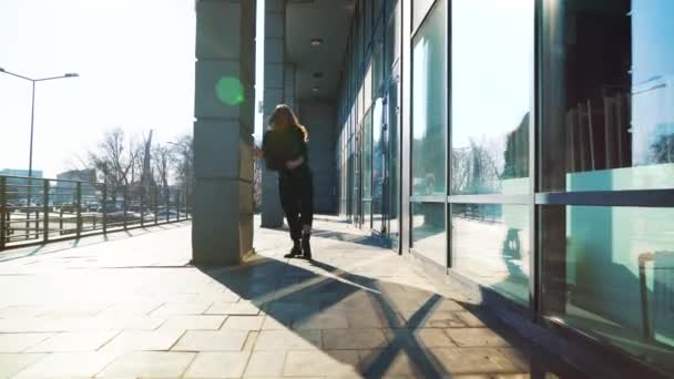 blonde woman contemporary dancer performing her dance in sunlit city street - Кадри, відео