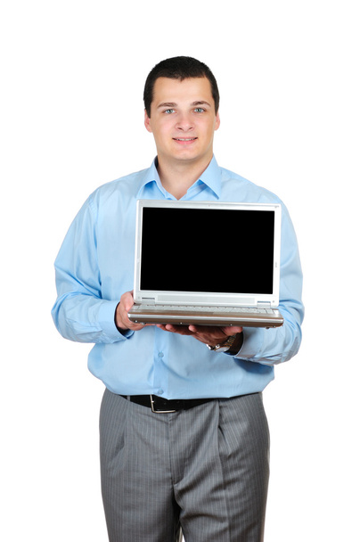 Businessman holding a laptop isolated on white - Фото, изображение