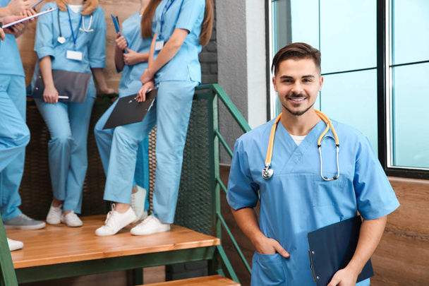 Medical student with groupmates in university hall - Фото, зображення