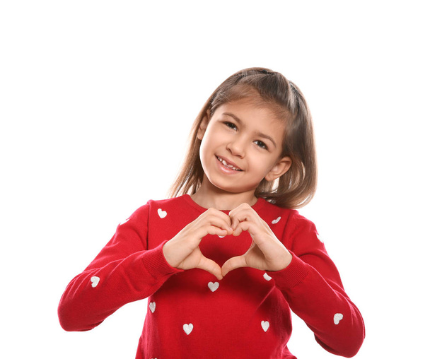 Little girl showing HEART gesture in sign language on white background - Фото, зображення
