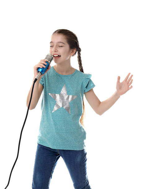 Cute girl singing in microphone on white background - 写真・画像