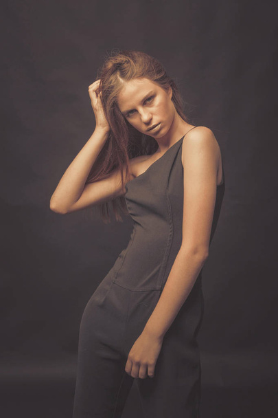 Fashionable girl in golden gray tones in studio. Woman with unfl - Foto, afbeelding