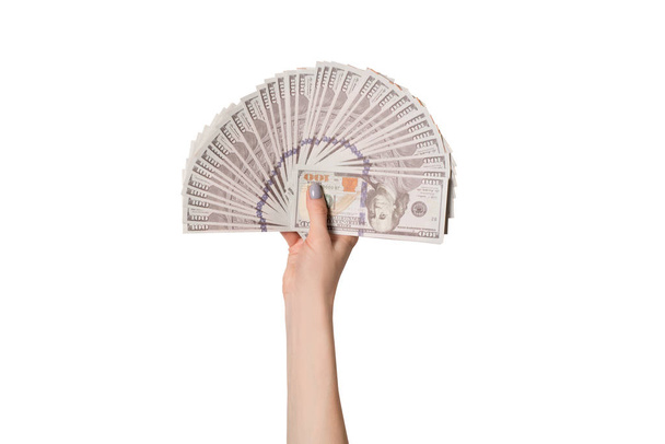 Female hand with a fan of 100 dollar American banknotes isolate on a white background - Zdjęcie, obraz