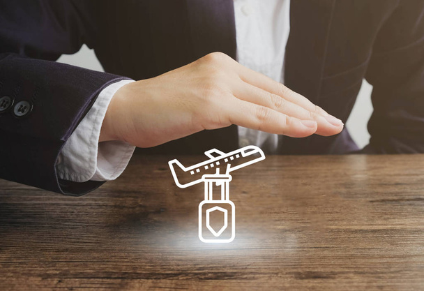 Businessman with airplane and baggage icon.Travel insurance concept - Foto, Imagen