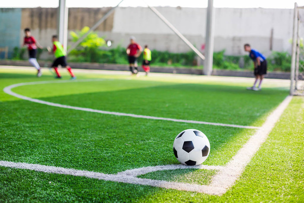 soccer ball on green artificial turf at corner of football field - Foto, Imagen