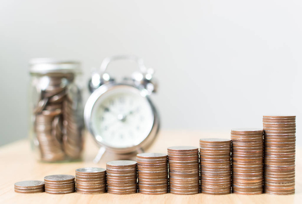 Coin stack step growing up to success financial business with clock and jar, Save money and investment concept, Copy space for your text - Foto, Imagen